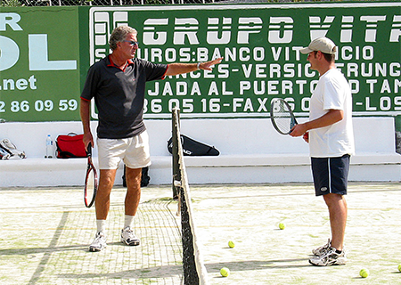 Photo of John giving tennis tips